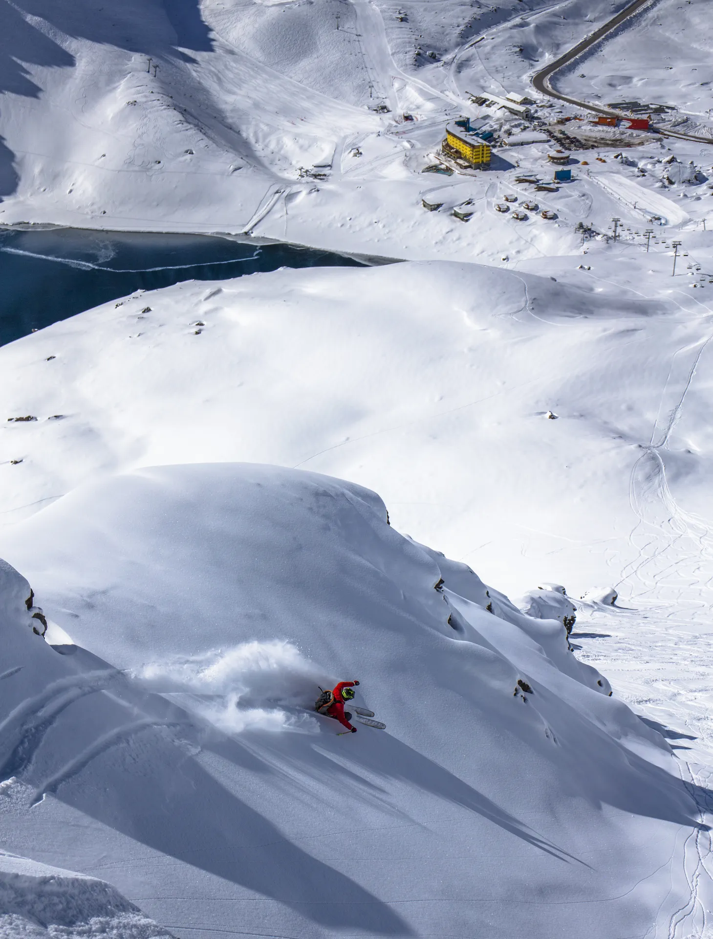 Powder skiing with resort below