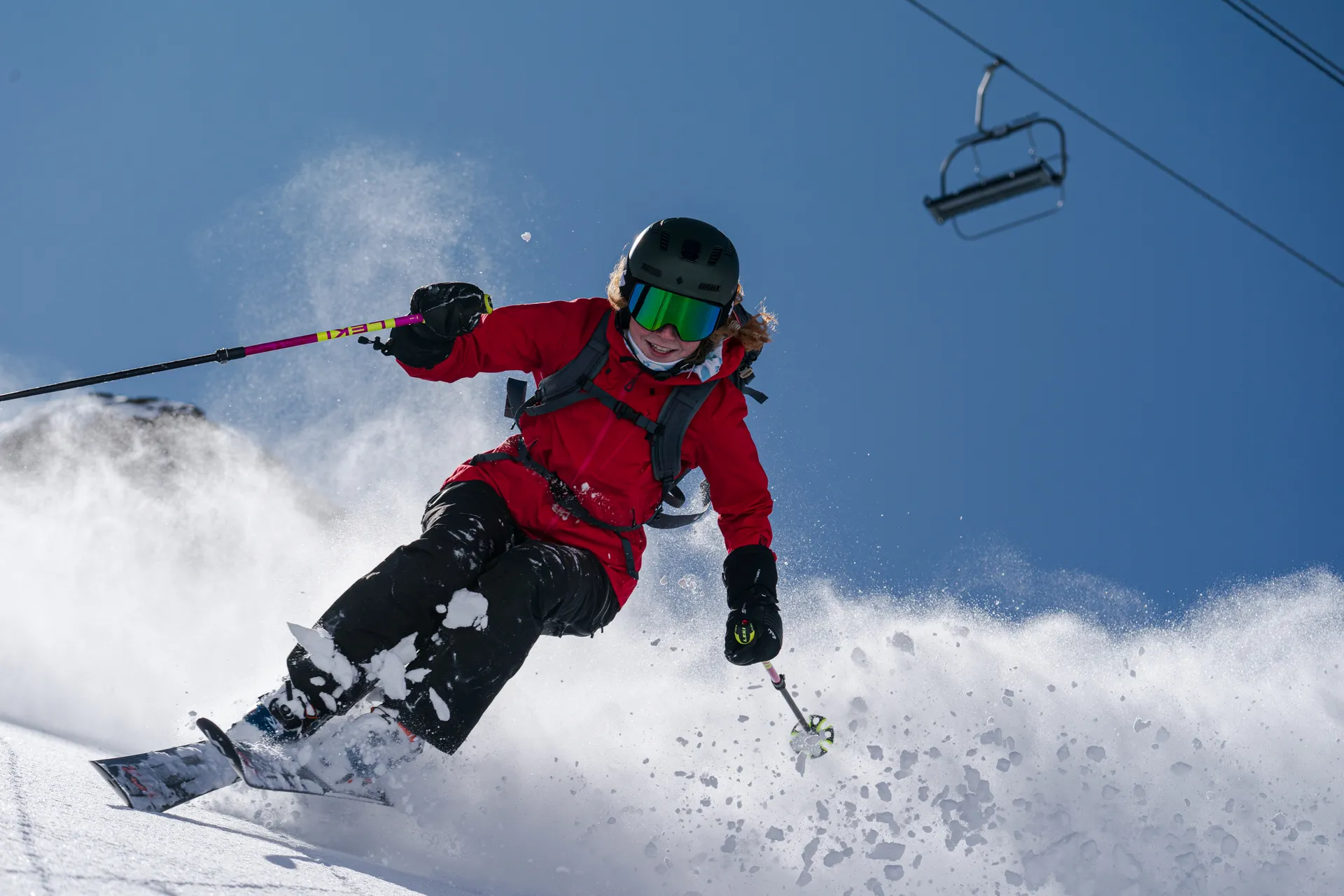 Red jacket skier in powder